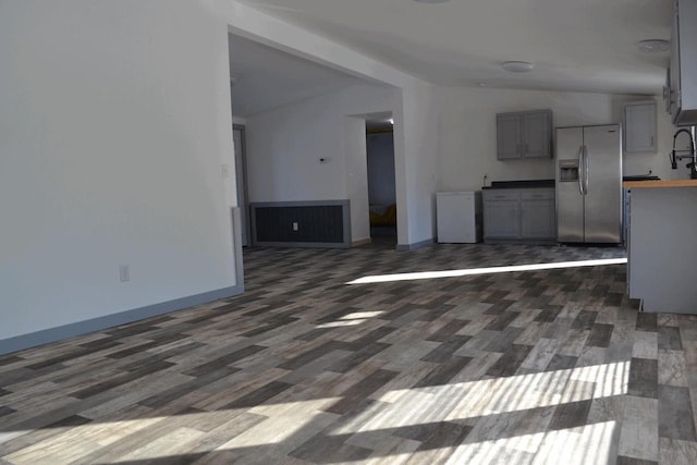 unfurnished living room featuring dark hardwood / wood-style floors