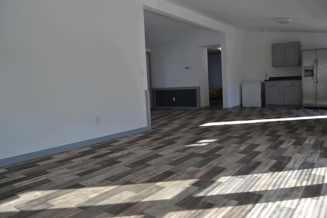 unfurnished living room with dark hardwood / wood-style flooring