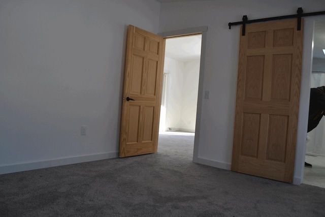 empty room with a barn door and carpet