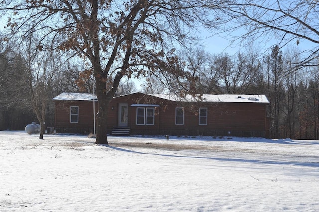 view of snow covered back of property