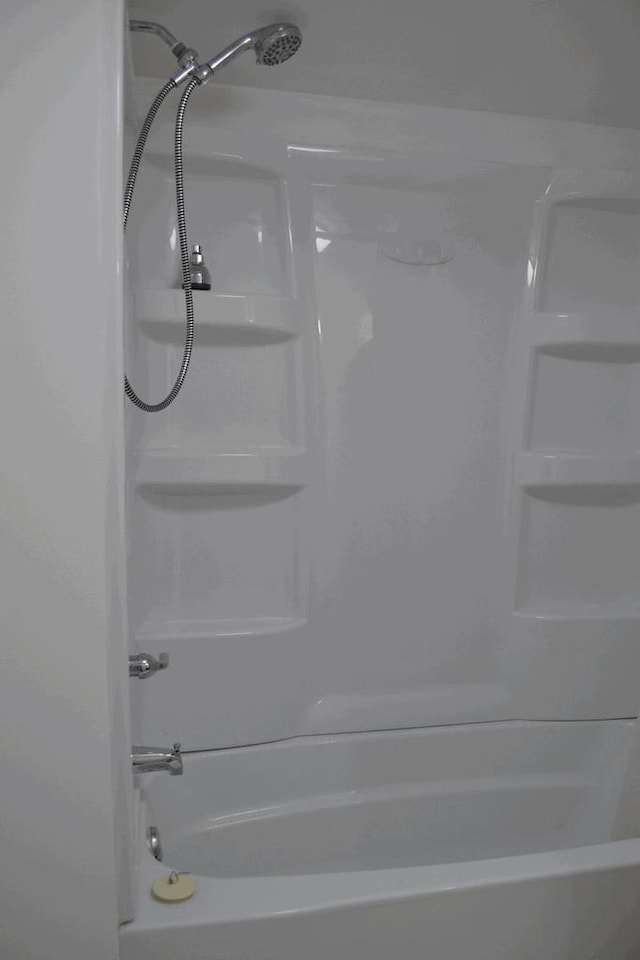 interior details featuring tub / shower combination