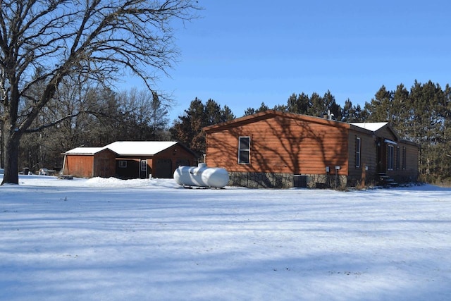 snow covered property with central AC