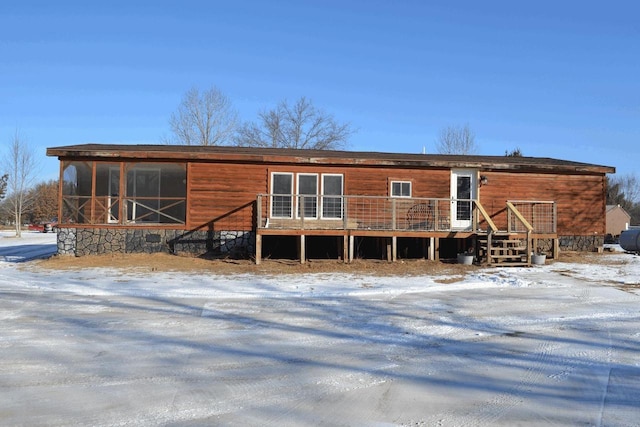 snow covered house featuring a deck