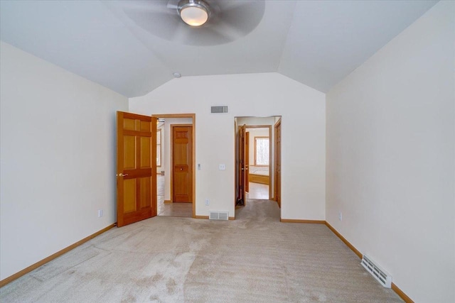 unfurnished bedroom featuring ceiling fan, lofted ceiling, and light carpet