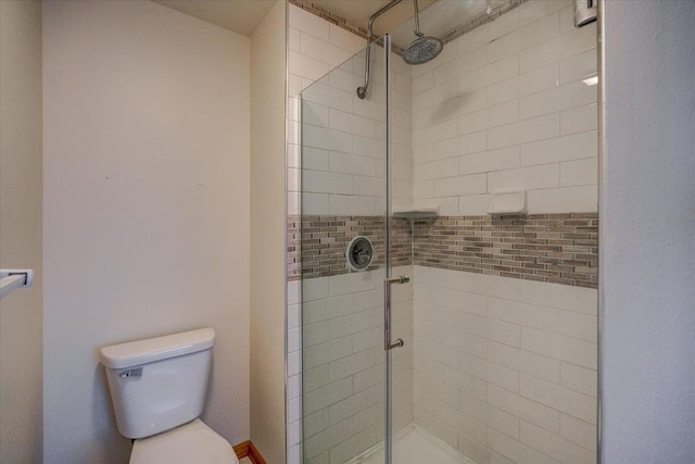 bathroom with toilet and an enclosed shower