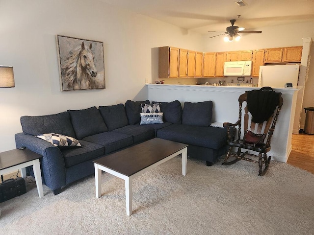 carpeted living room featuring ceiling fan