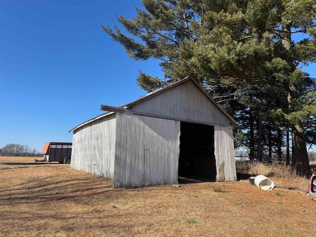 view of outbuilding featuring a yard