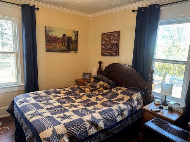 bedroom featuring crown molding and a textured ceiling