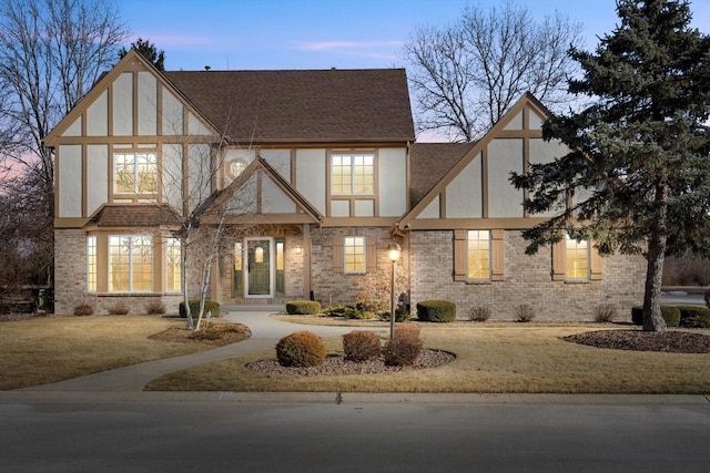 tudor home featuring a lawn