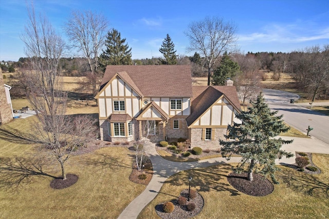 tudor home featuring a front lawn