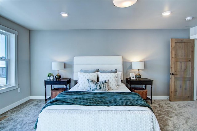 carpeted bedroom with multiple windows