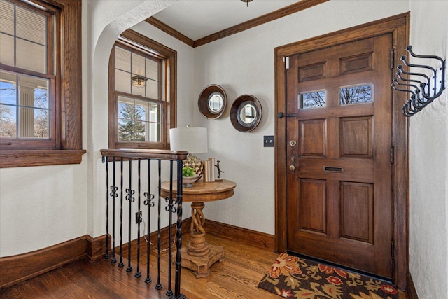 foyer entrance featuring wood-type flooring and ornamental molding