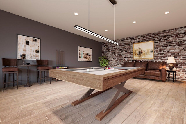 playroom featuring brick wall, pool table, and light wood-type flooring