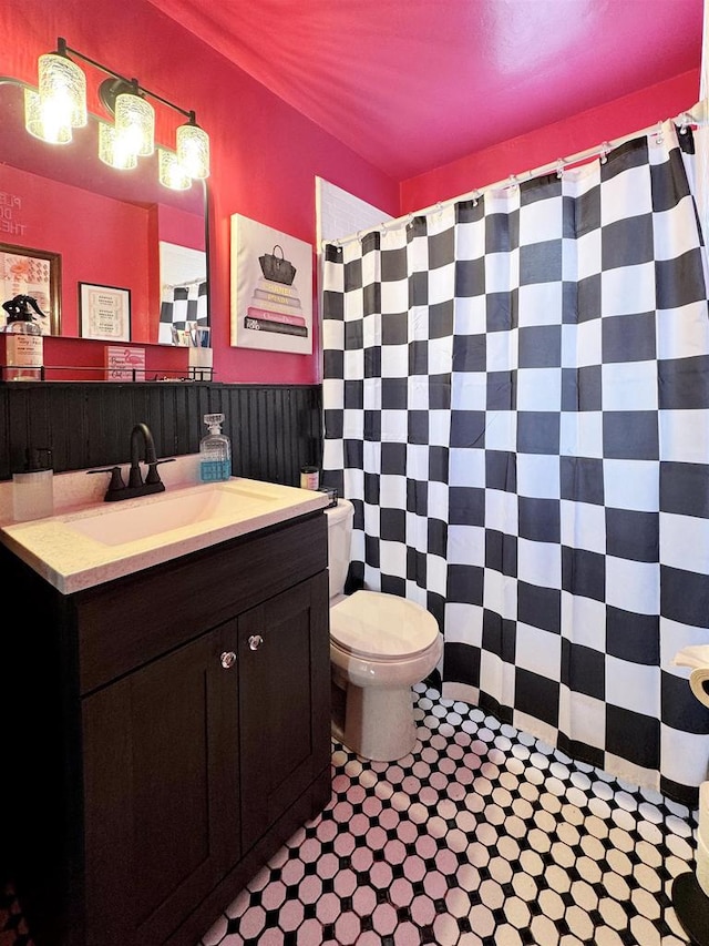 bathroom featuring vanity and toilet