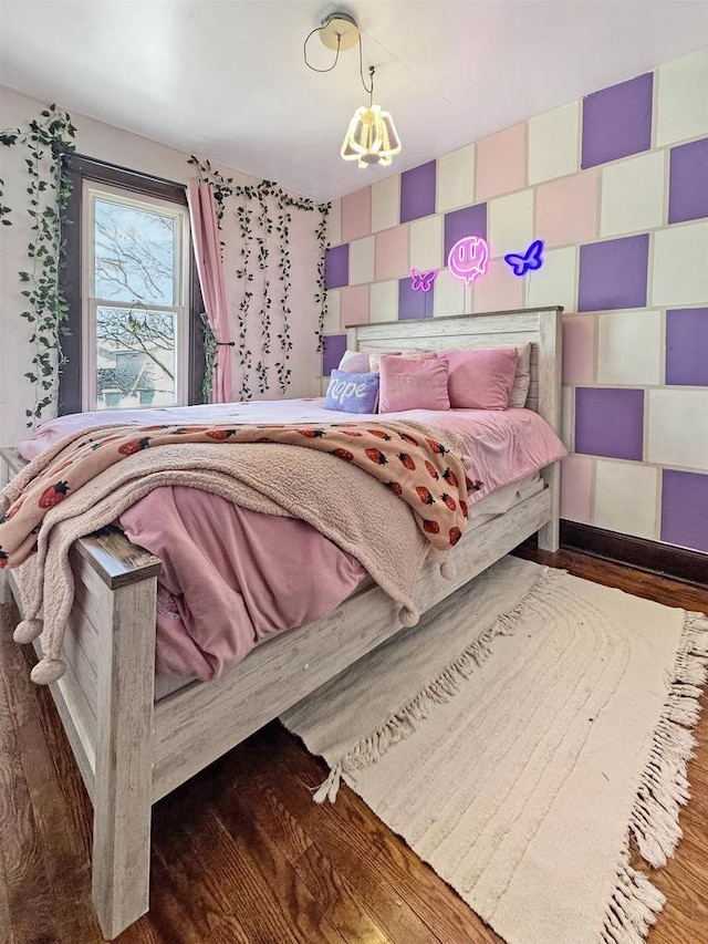 bedroom featuring dark wood-type flooring and a notable chandelier