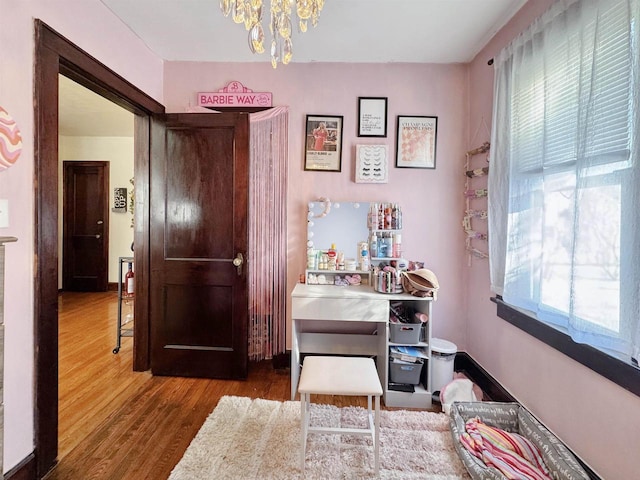 interior space featuring hardwood / wood-style floors, plenty of natural light, and a chandelier