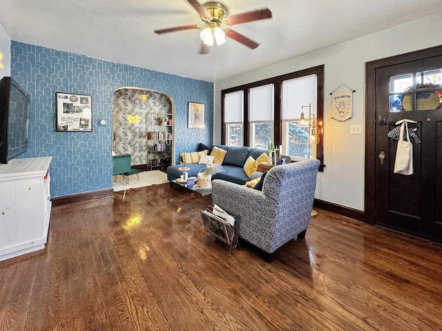 living room with ceiling fan and dark hardwood / wood-style flooring