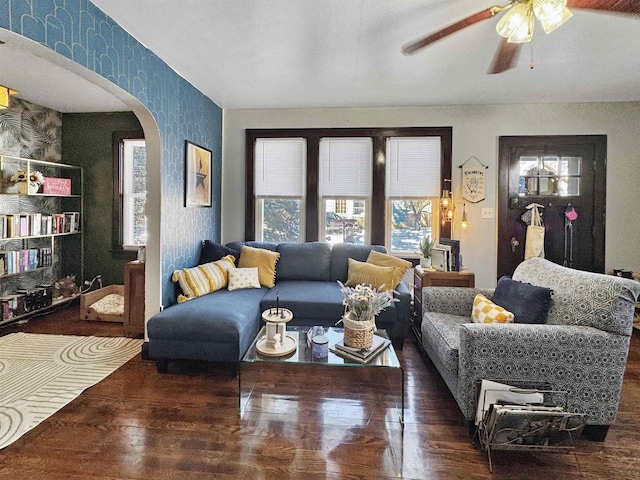 living room with dark wood-type flooring and ceiling fan