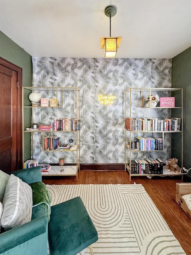 sitting room with wood-type flooring