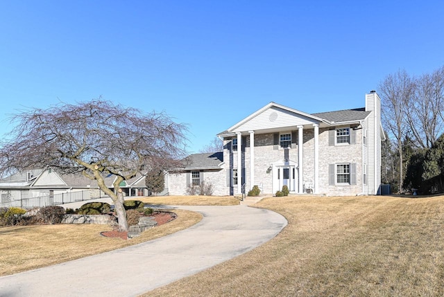 greek revival inspired property with a front lawn