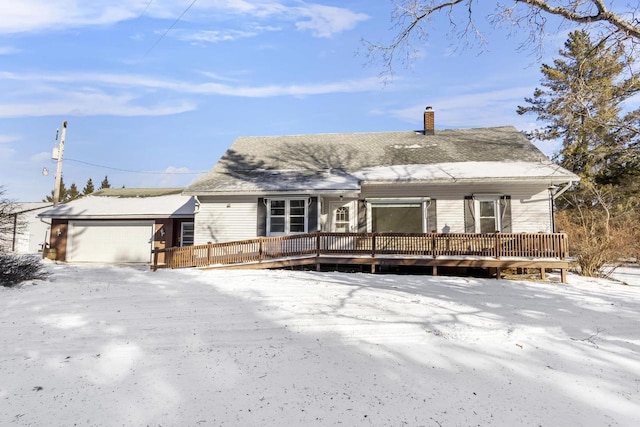 view of front facade featuring a wooden deck and a garage