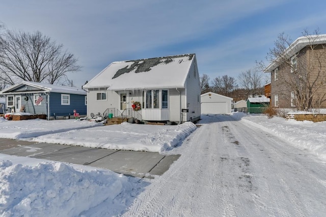 view of front of property with a garage and an outdoor structure