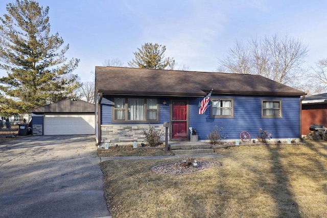 view of front of house with an outbuilding, a garage, and a front lawn