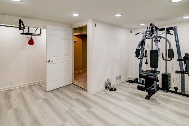 workout area with light wood-type flooring