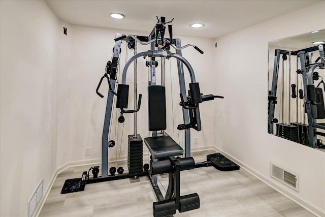 exercise area with light hardwood / wood-style floors