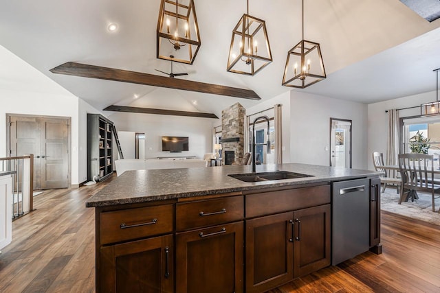 kitchen with dishwasher, sink, pendant lighting, and vaulted ceiling with beams