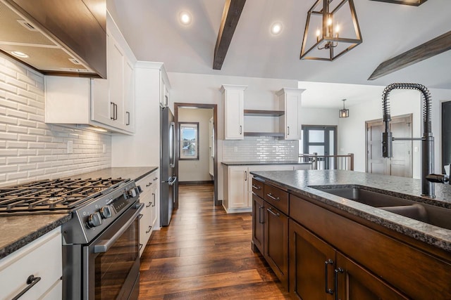 kitchen with appliances with stainless steel finishes, decorative light fixtures, extractor fan, and white cabinets