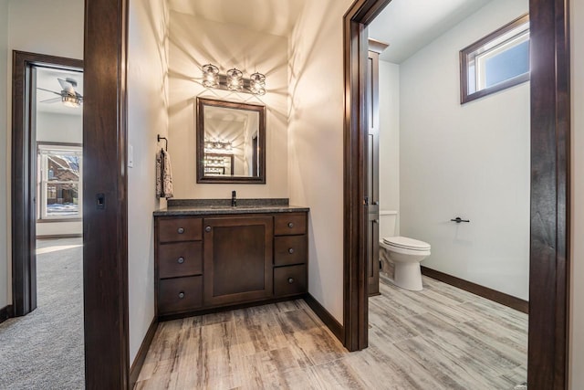 bathroom with vanity, hardwood / wood-style floors, and toilet