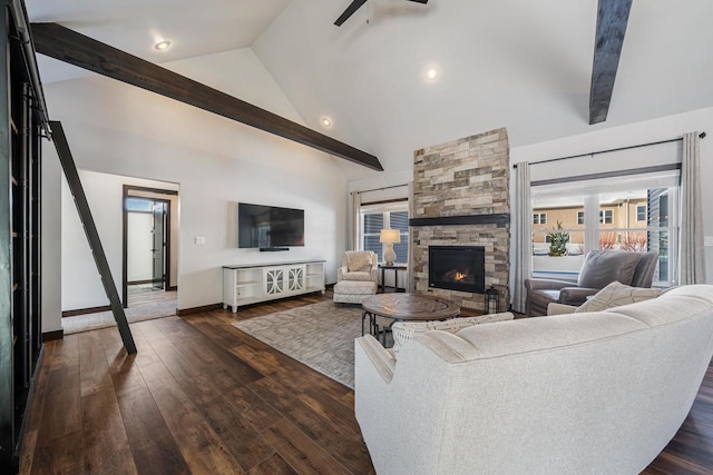 living room with beamed ceiling, a stone fireplace, dark hardwood / wood-style floors, and high vaulted ceiling