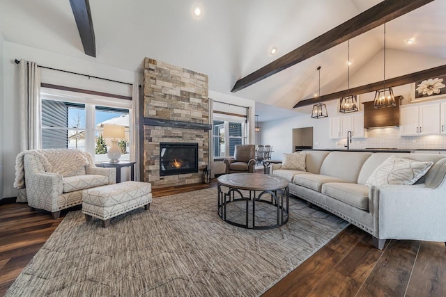 living room featuring a fireplace, dark hardwood / wood-style floors, high vaulted ceiling, and beam ceiling