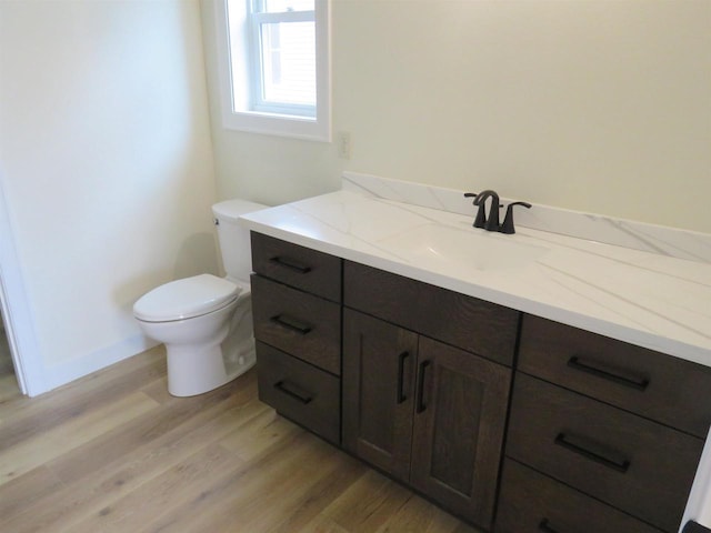 127 Linden Ln, Fox Lake, WI 53933 - half bathroom featuring vanity and wood finished floors