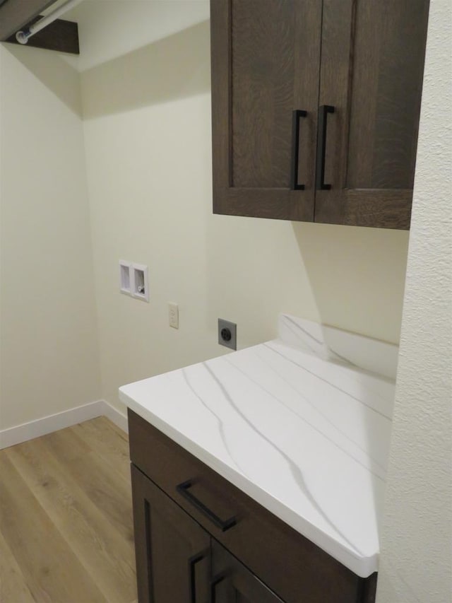 127 Linden Ln, Fox Lake, WI 53933 - laundry area featuring electric dryer hookup, cabinet space, washer hookup, and light wood-style flooring
