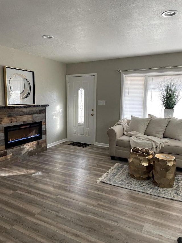 living room featuring dark hardwood / wood-style floors and a textured ceiling