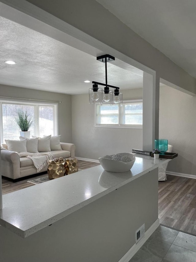 living room featuring wood-type flooring and a textured ceiling