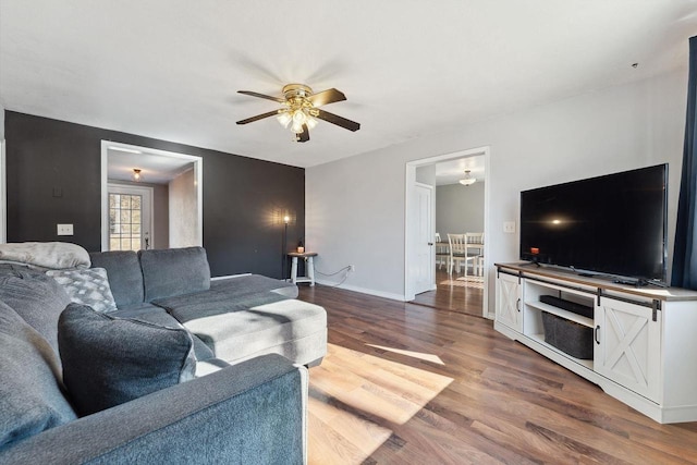 living room featuring hardwood / wood-style flooring and ceiling fan