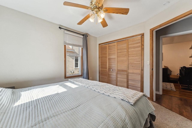 bedroom featuring hardwood / wood-style flooring, ceiling fan, and a closet