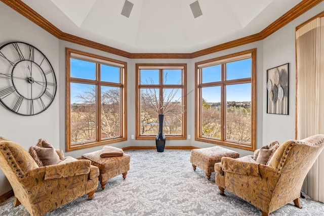 living area with ornamental molding and carpet