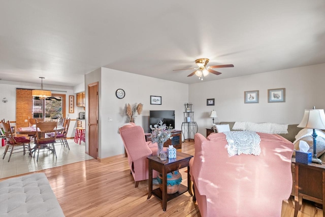 living room featuring ceiling fan and light wood-type flooring