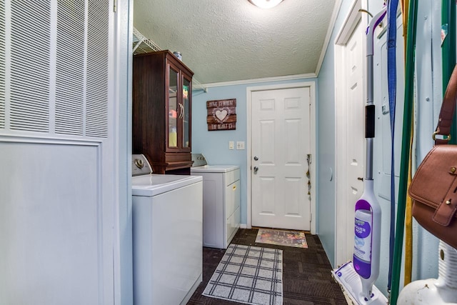 clothes washing area featuring a textured ceiling and washer and clothes dryer