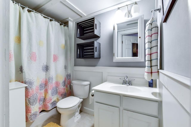 bathroom featuring vanity, tile patterned floors, and toilet