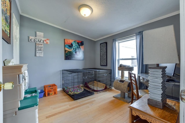 bedroom with wood-type flooring, lofted ceiling, a textured ceiling, and crown molding