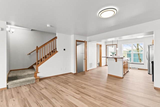 unfurnished living room with light wood-type flooring