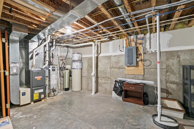 basement with heating unit, gas water heater, and electric panel