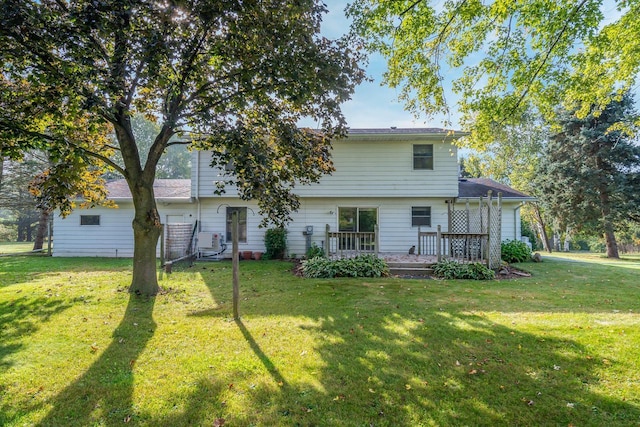 back of house featuring a yard and a deck