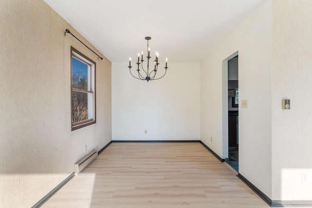 unfurnished dining area featuring a notable chandelier, baseboard heating, and light hardwood / wood-style floors