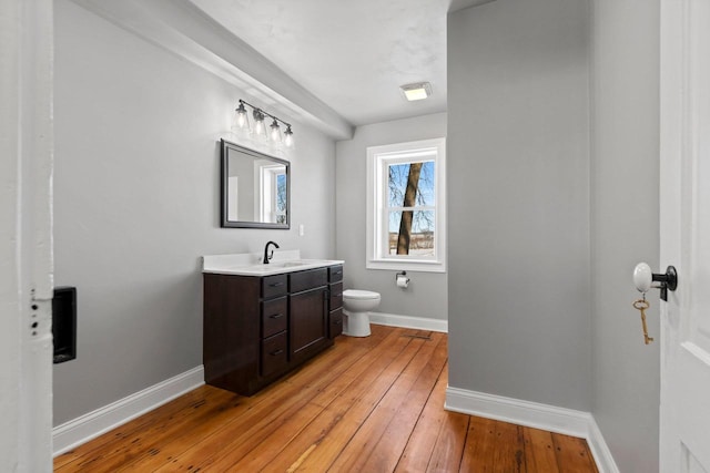 bathroom with vanity, wood-type flooring, and toilet